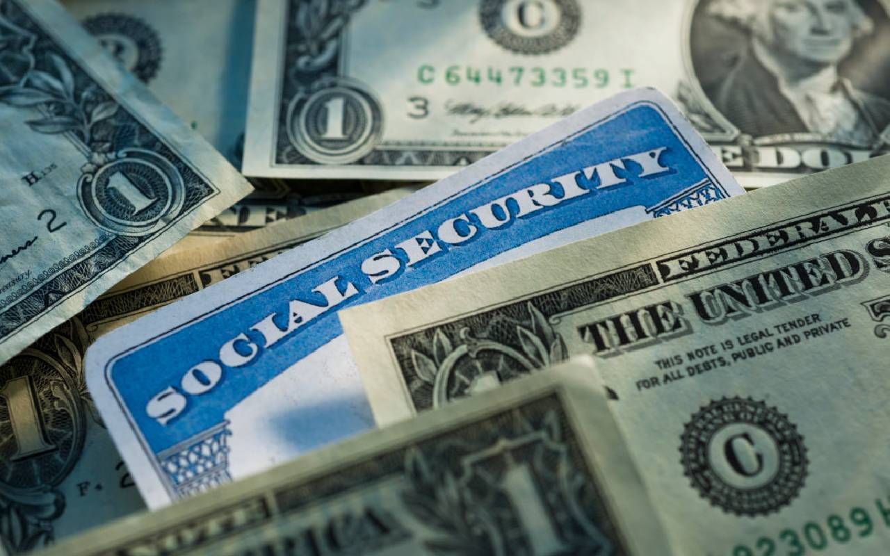U.S. dollar bills and a social security card. Next Avenue, social security retirement benefits