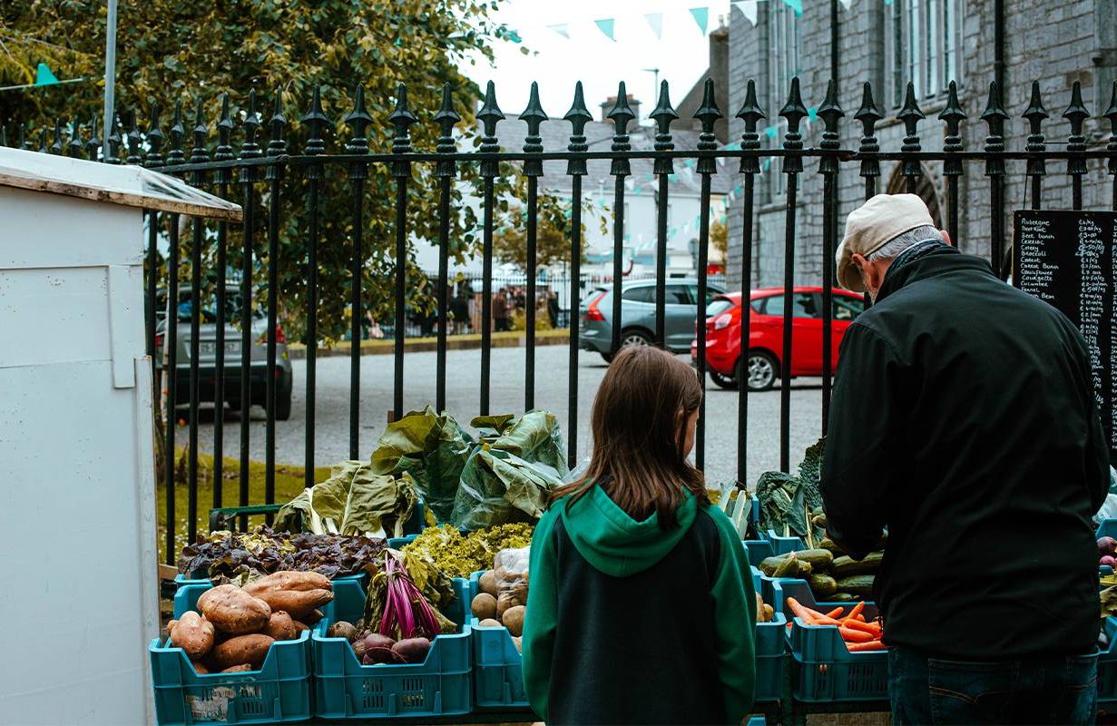 A person buying food at the farmer's market. Next Avenue, rising food costs
