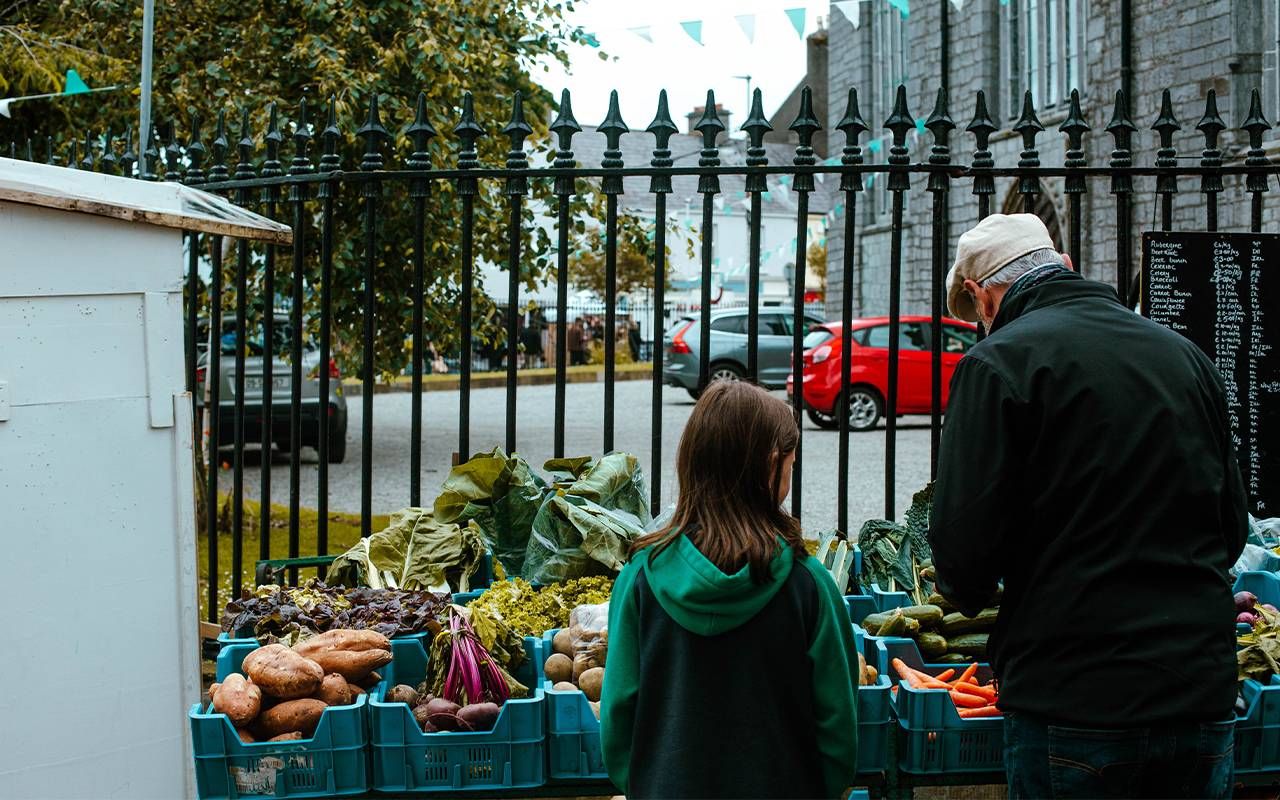 A person buying food at the farmer's market. Next Avenue, rising food costs