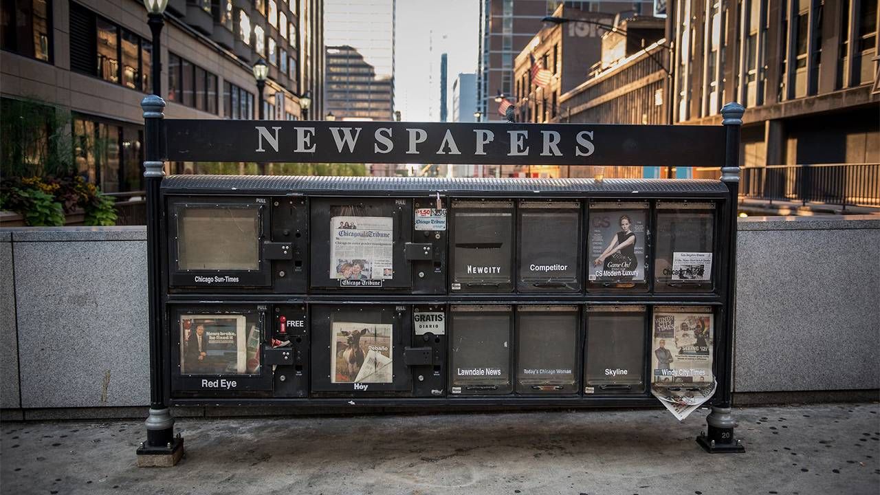 A newsstand with very few newspapers in it. Next Avenue, local news, desert