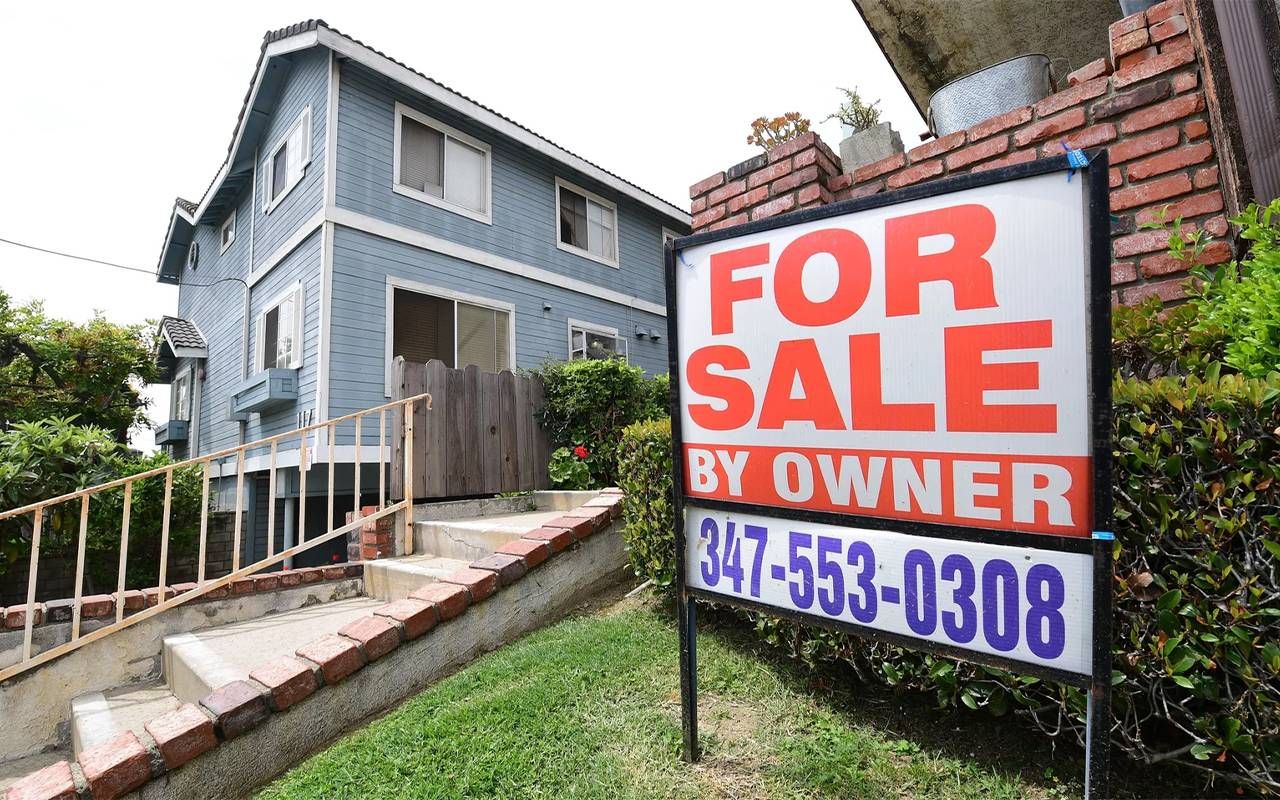 A "For Sale By Owner" sign outside of a home. Next Avenue, retirement wealth gap