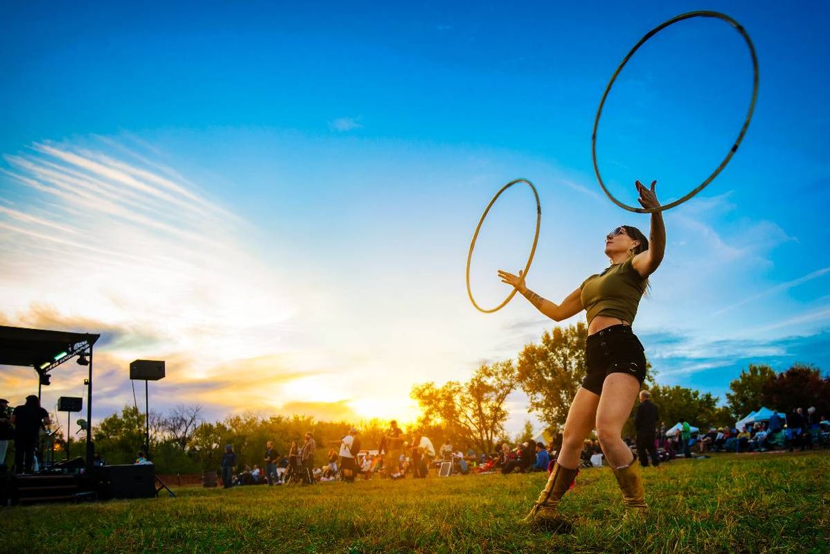 A person hula hooping in a grassy field. Next Avenue, summer art festivals, 2023