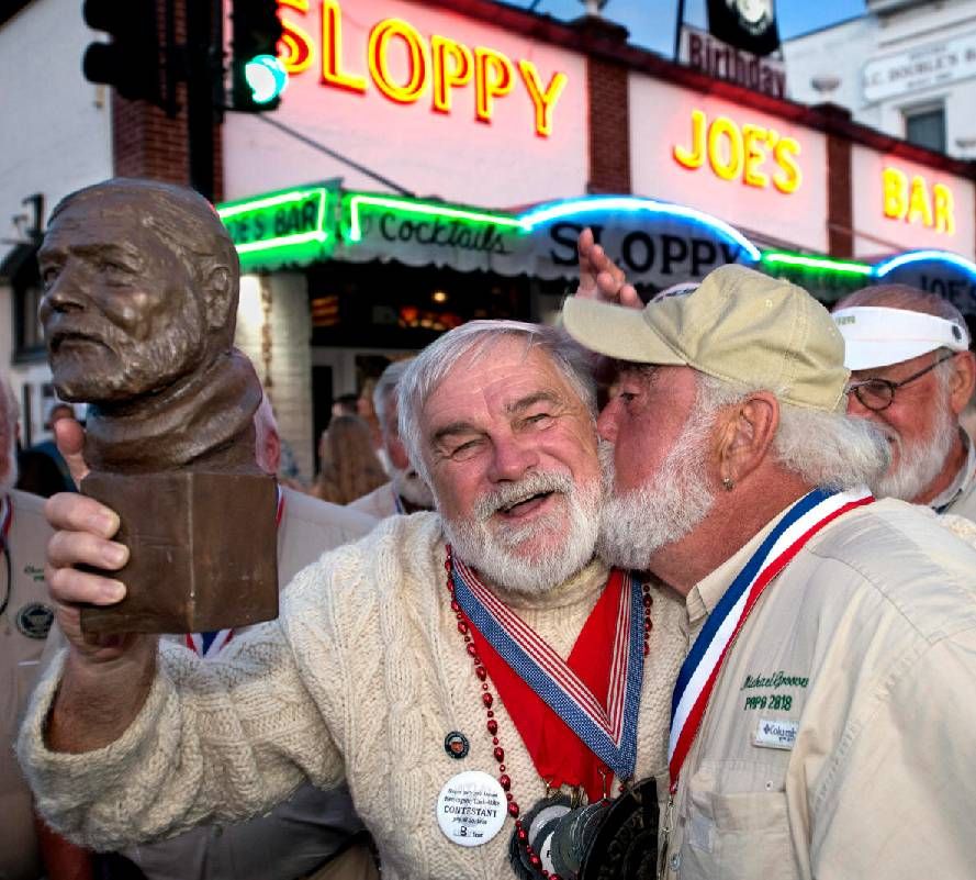 Two Hemingway lookalikes celebrating after a contest. Next Avenue, summer art festivals, 2023