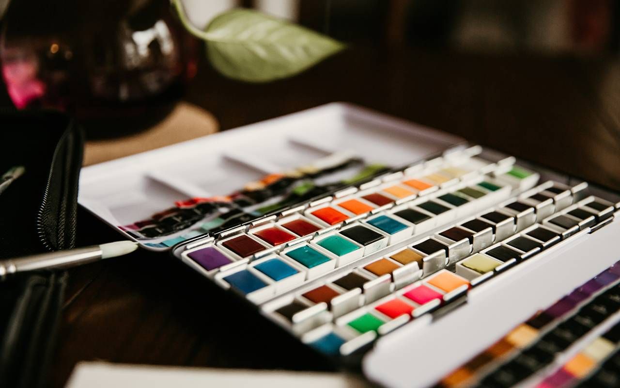 A watercolor paint palette on a table. Next Avenue, art, creativity