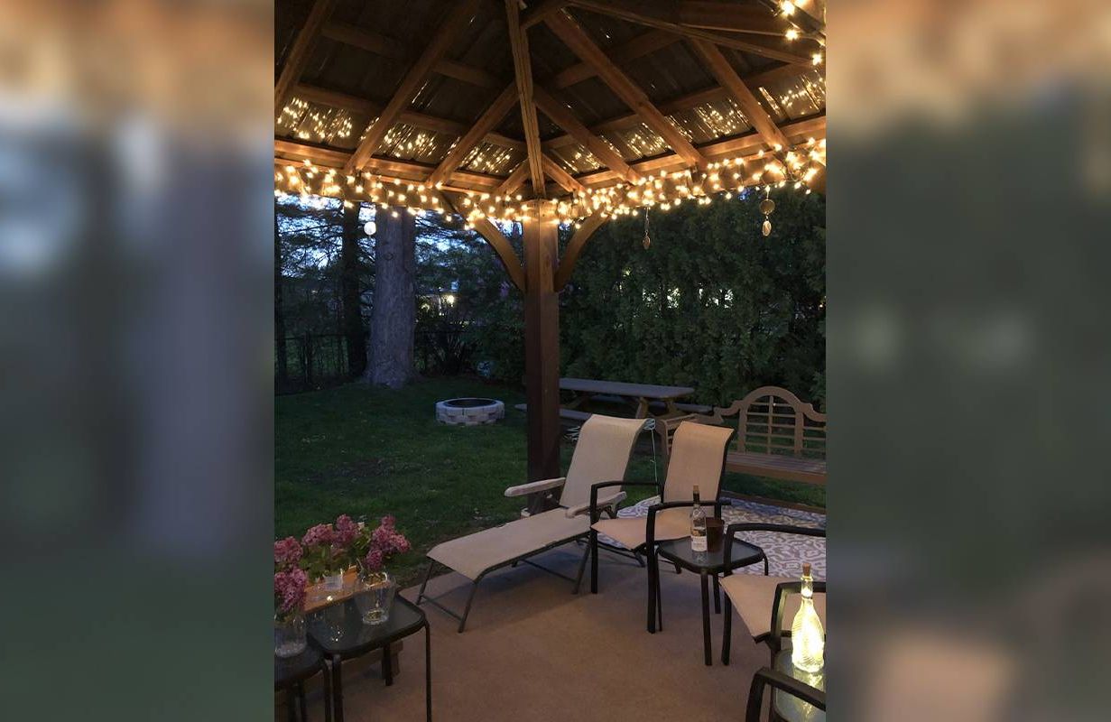 A gazebo with lights and patio chairs. Next Avenue