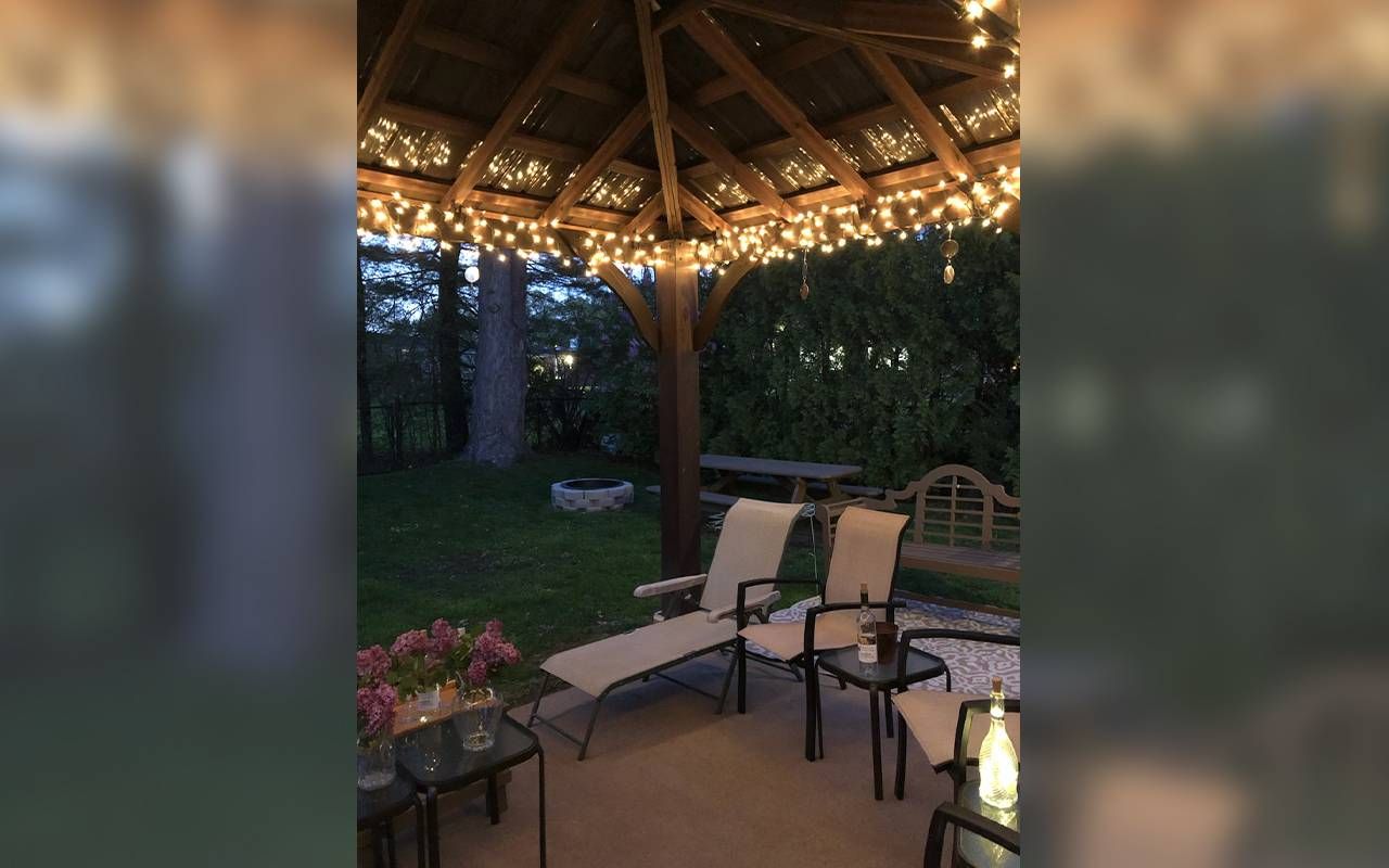 A gazebo with lights and patio chairs. Next Avenue