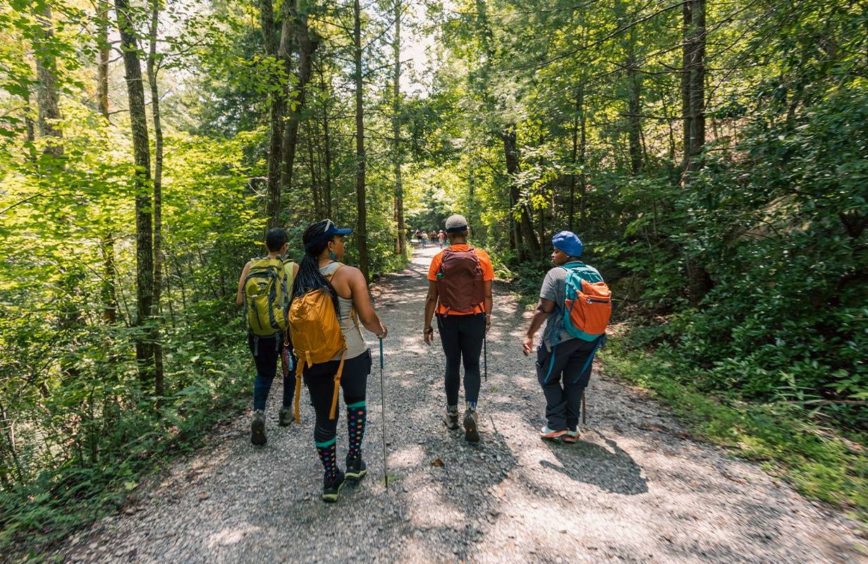 A group of people hiking on a trail. Next Avenue, build a trail, legacy