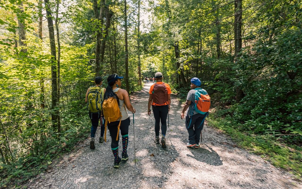 A group of people hiking on a trail. Next Avenue, build a trail, legacy