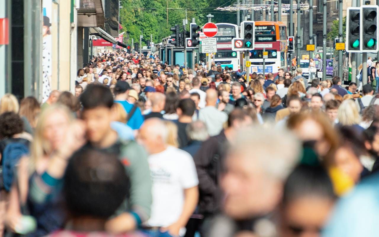 A crowded street with people walking. Next Avenue, culture of busyness