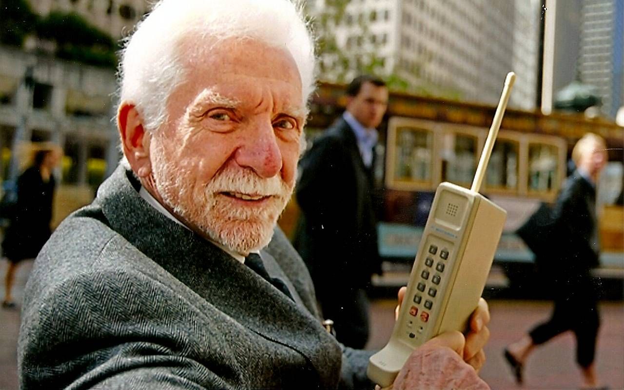 A man holding an old cellphone in New York City. Next Avenue