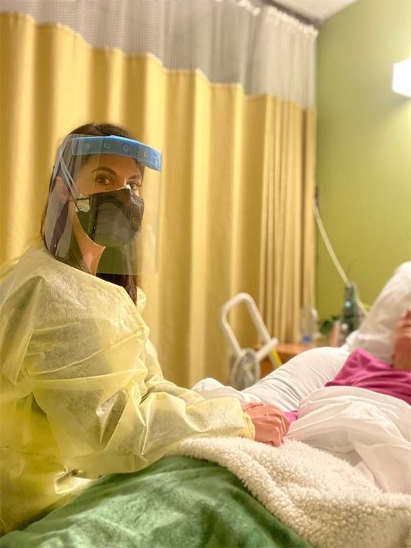 A woman holding her grandmother's hand in a hospitalNext Avenue, millennial caregiver