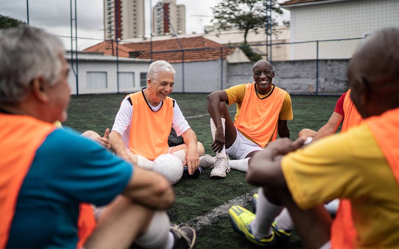 A team of older men gathering together before a soccer game. Next Avenue