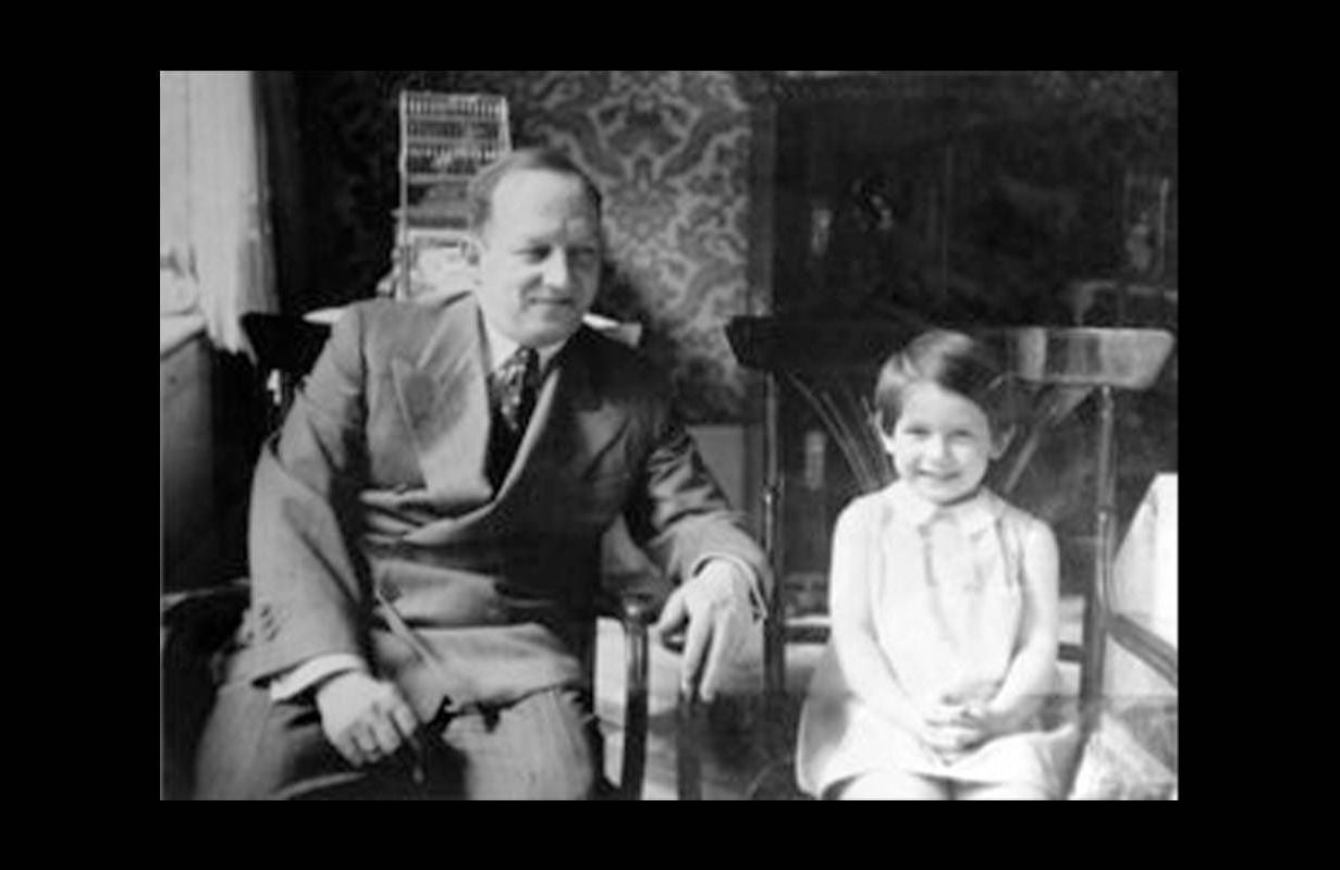 An old photo of a father sitting in a chair next to his young daughter. Next Avenue, Holocaust Lessons
