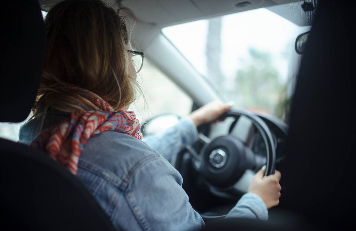 A young adult driving a car. Next Avenue, millennial caregiver