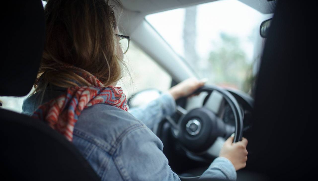 A young adult driving a car. Next Avenue, millennial caregiver