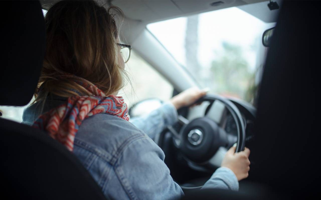 A young adult driving a car. Next Avenue, millennial caregiver