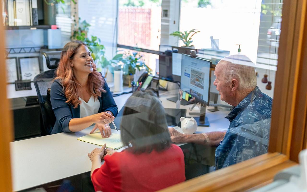 An older couple meeting with an insurance agent. Next Avenue