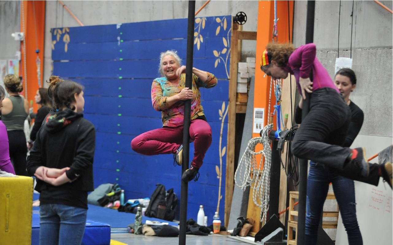 People doing acrobatics on a pole. Next Avenue, Vermont, Art communities