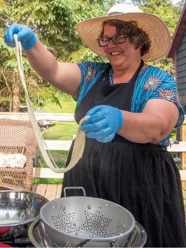 A woman smiling and making cheese. Next Avenue, Vermont, Art communities