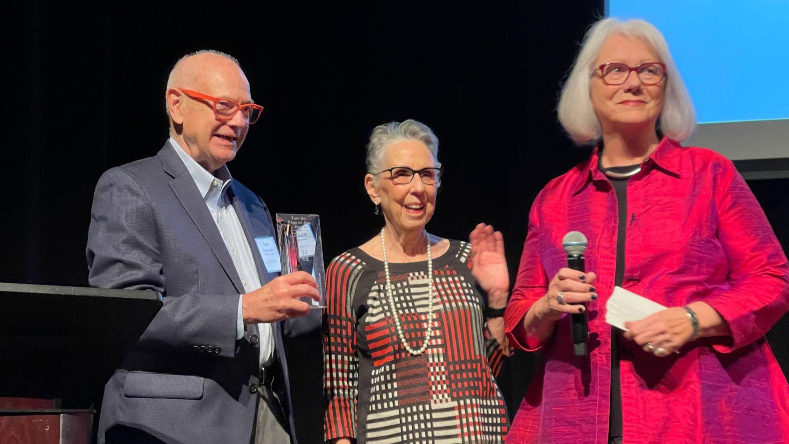 Two women on stage accepting an award. Next Avenue, women over 70 podcast