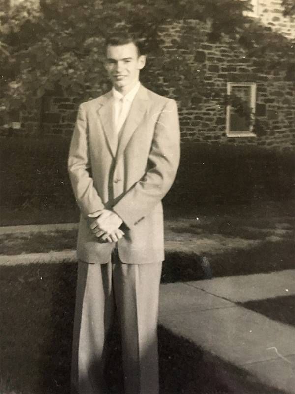 A black and white photo of a man wearing a suit. Next Avenue