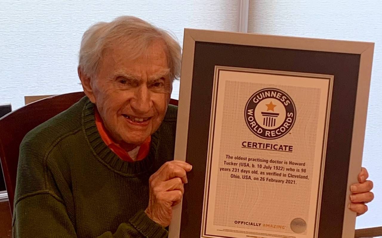 A man holding a Guinness World Record certificate. Next Avenue