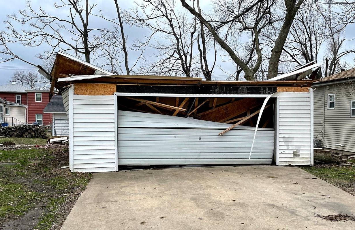 A garage with a caved in roof and severe damage. Next Avenue, insurance