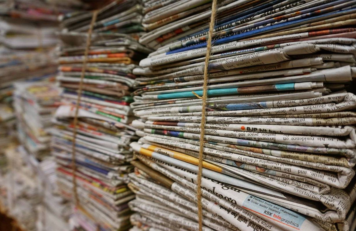 A stack of newspapers. Next Avenue