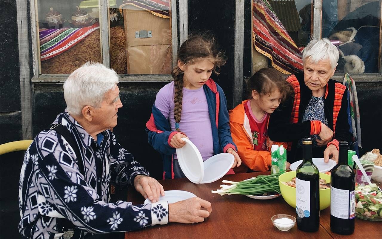 Retired grandparents having a picnic with their grandchildren. Next Avenue, retirement advice