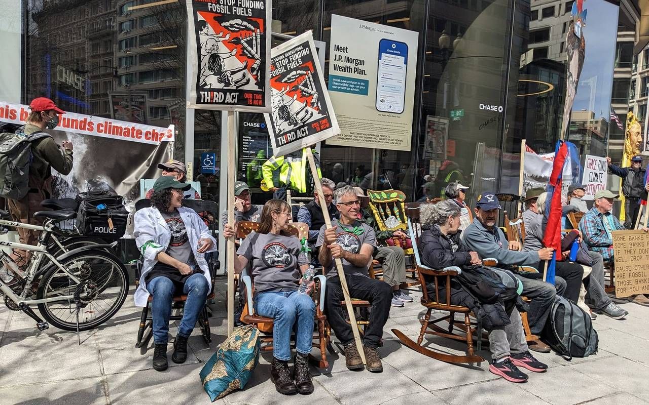A group of protesters sitting in rocking chairs outside of a bank. Next Avenue, Third Act, Rocking Chair Rebellion