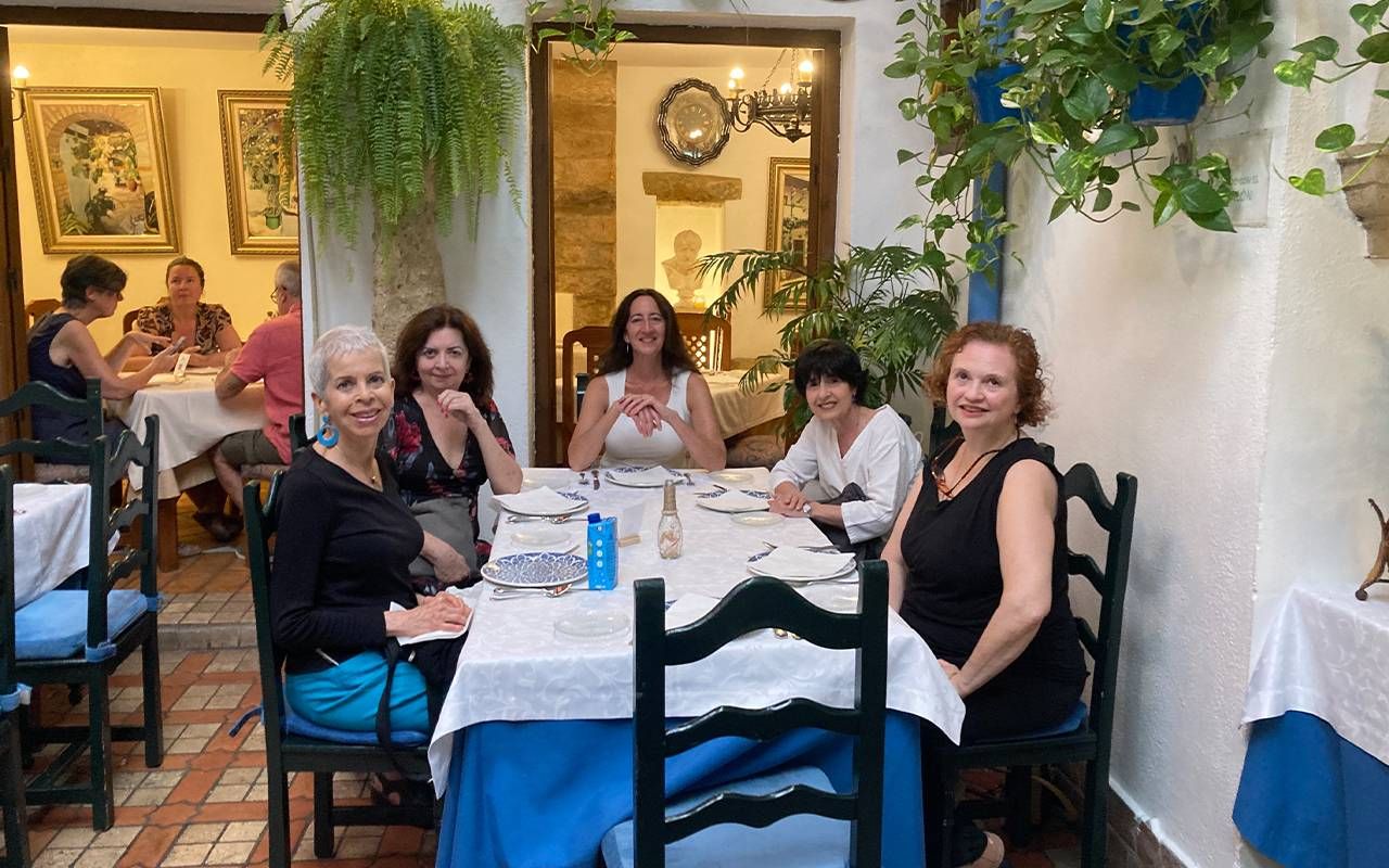 A group sitting at a table in a restaurant. Next Avenue