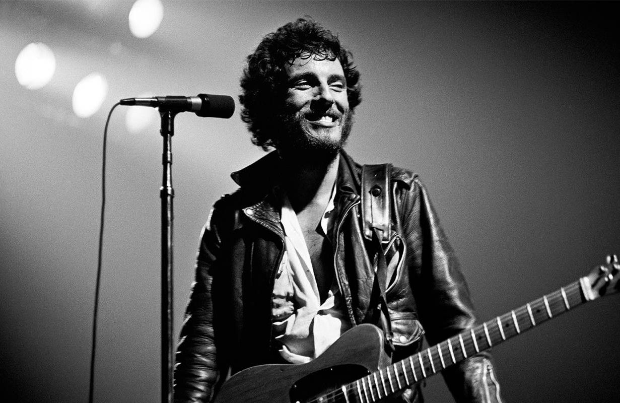 A black and white photo of Bruce Springsteen in the 70s. Next Avenue