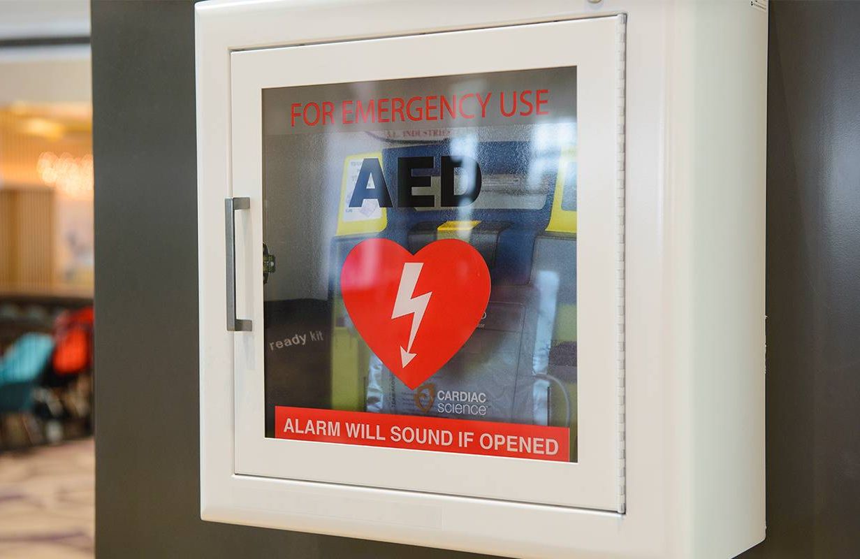 An Automated External Defibrillator/AED on a wall. Next Avenue