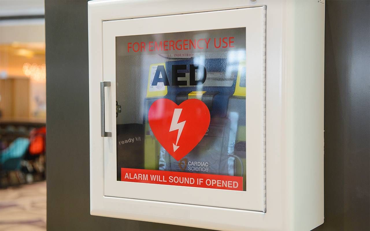 An Automated External Defibrillator/AED on a wall. Next Avenue