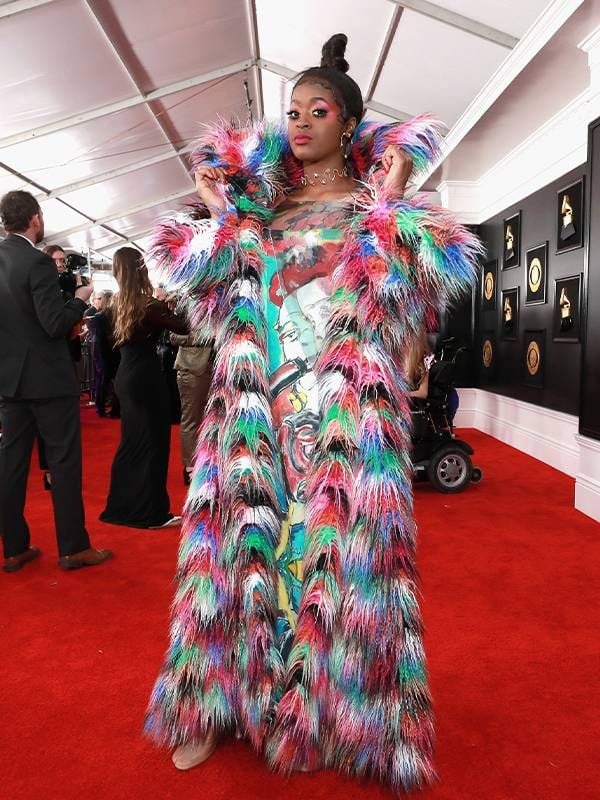 A person wearing a colorful gown on a red carpet. Next Avenue, Nancy Volpe-Beringer