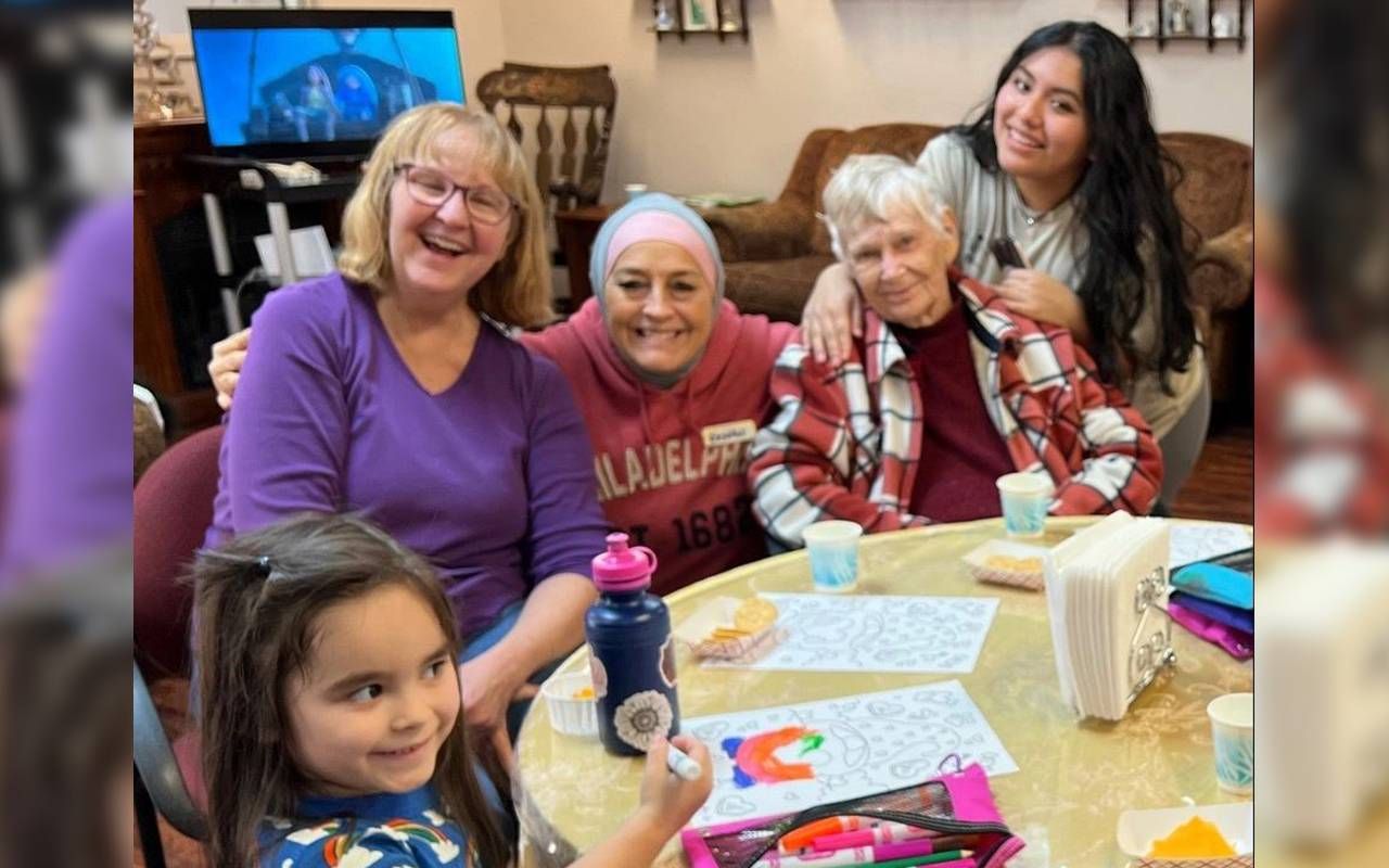 A group of people of all ages sitting together at a table.Next Avenue