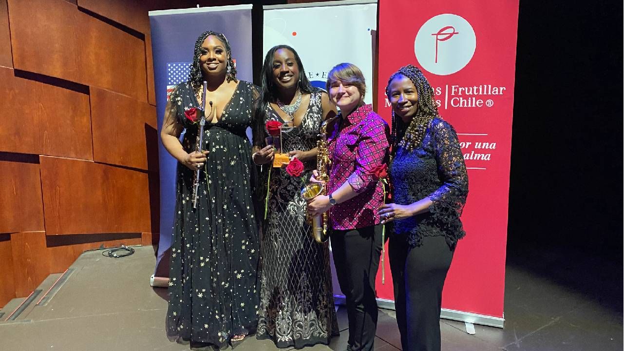 Four woman smiling together and holding roses. Next Avenue