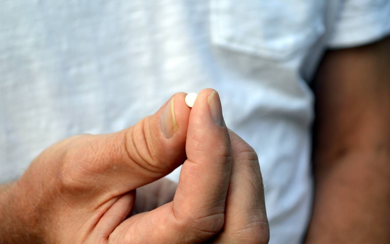 A person holding a melatonin pill. Next Avenue