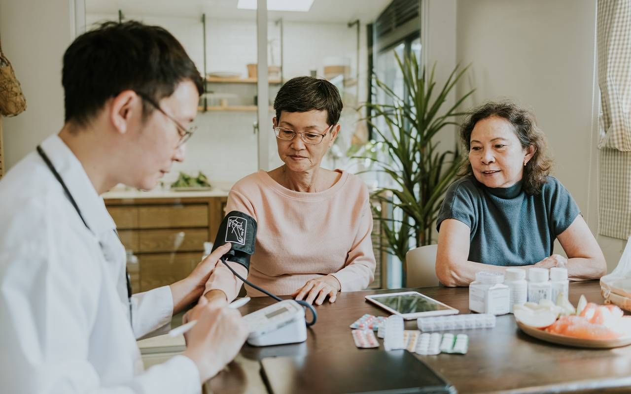 Two people attending a doctor's appointment together. Next Avenue LGBTQ caregivers, elders