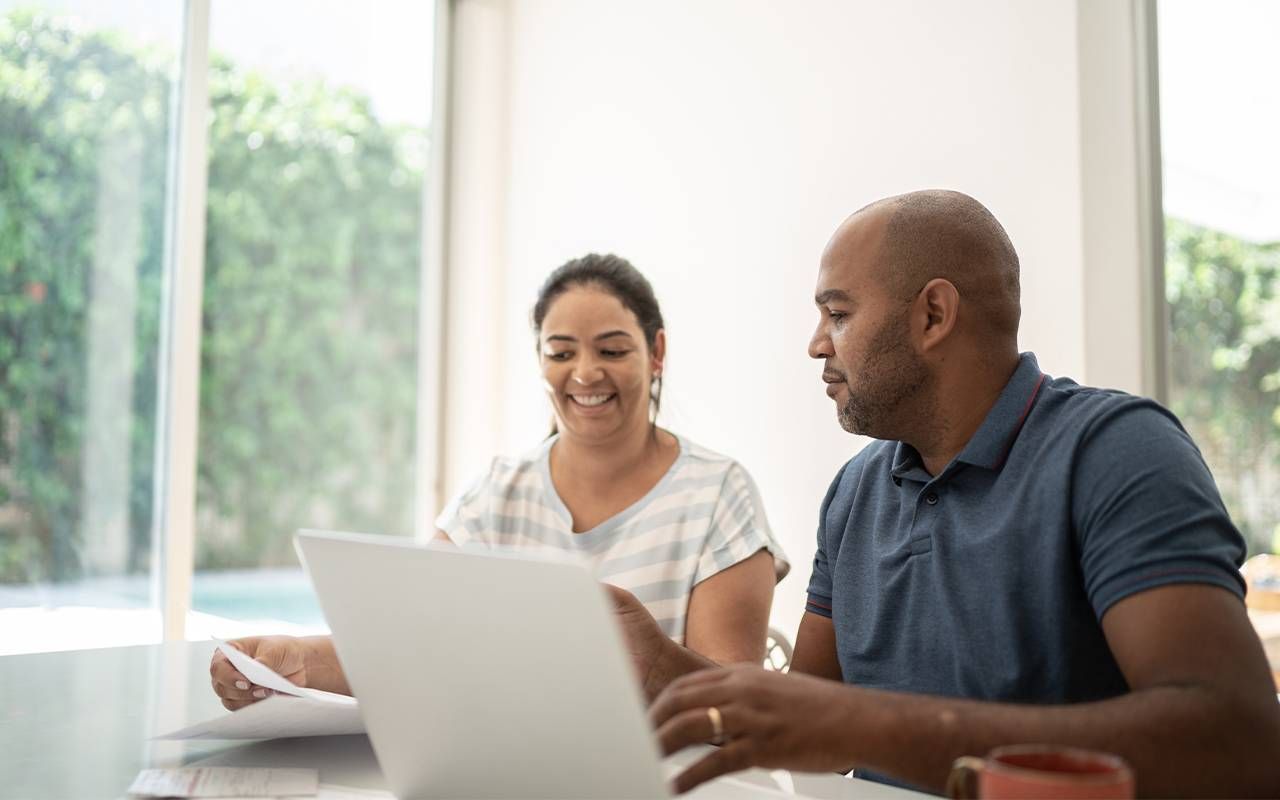 A couple going through their budget at home. Next Avenue