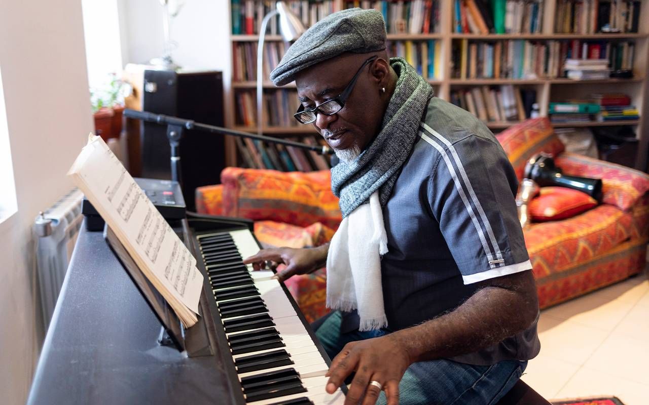 A man practicing the piano at home. Next Avenue