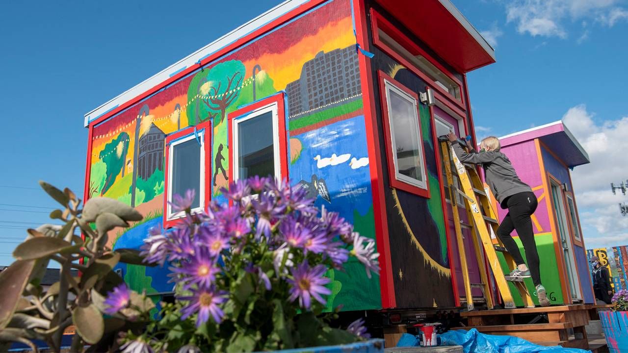 A small colorful house with a mural. Next Avenue