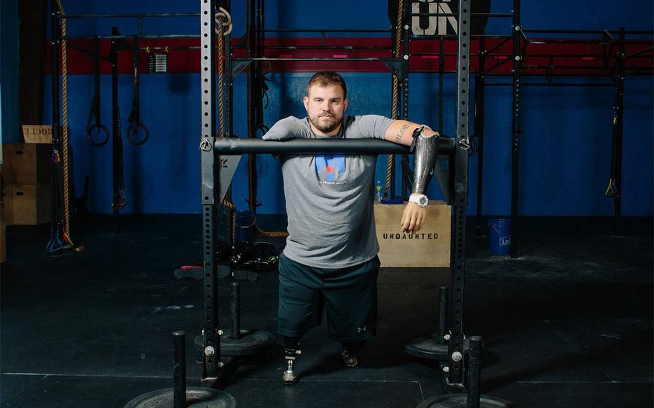 A man with limb loss at the gym. Next Avenue