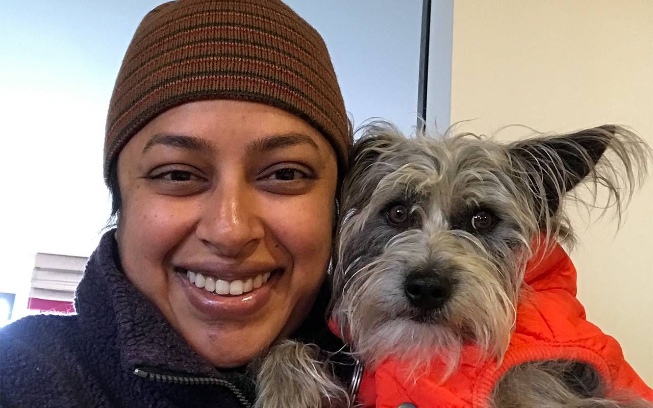 A headshot of a woman holding her small grey dog. Next Avenue