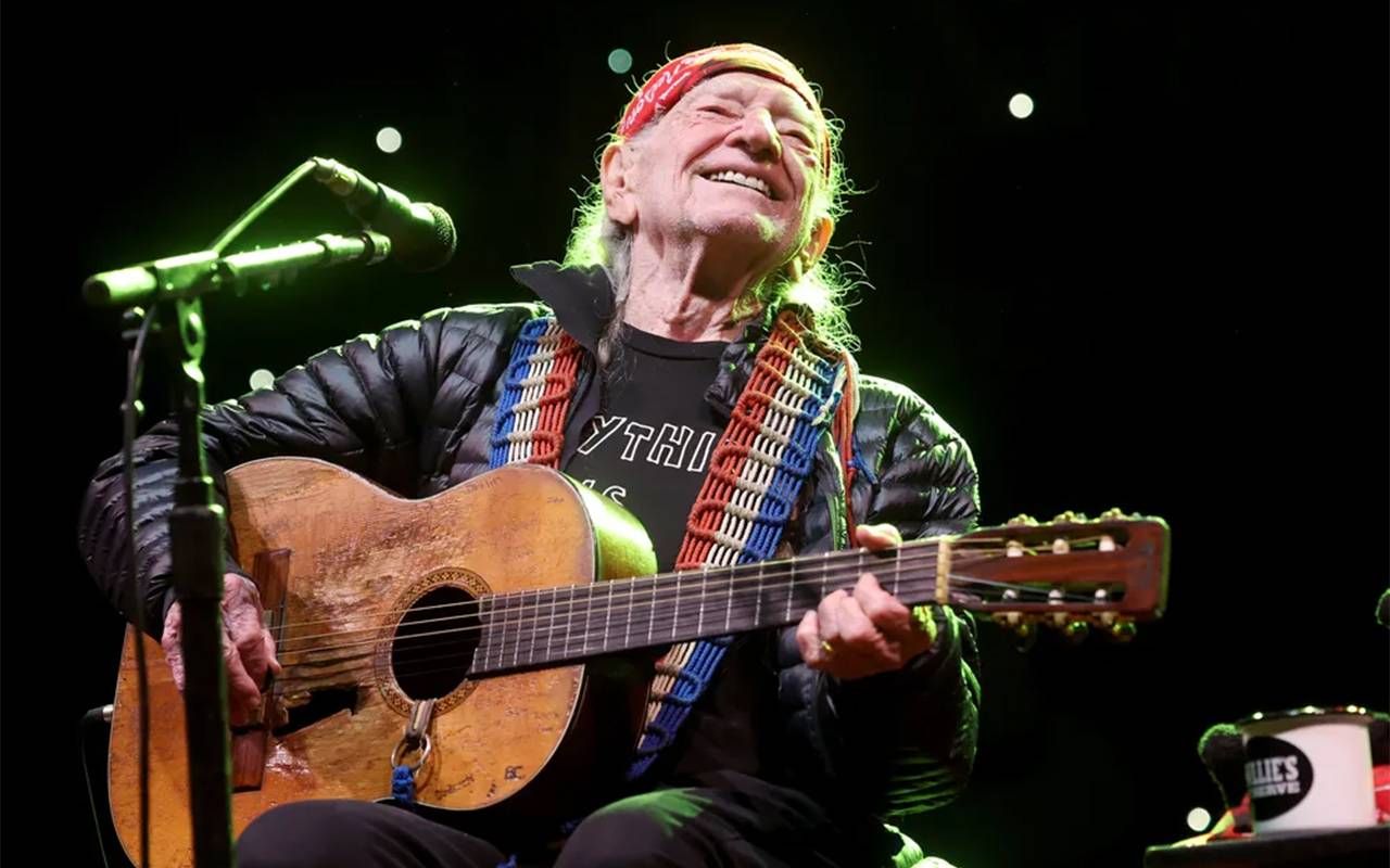 Willie Nelson performing on stage. Next Avenue