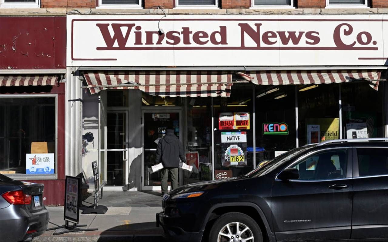 The exterior of a person delivering bundles of newspaper to a local store. Next Avenue, local journalism