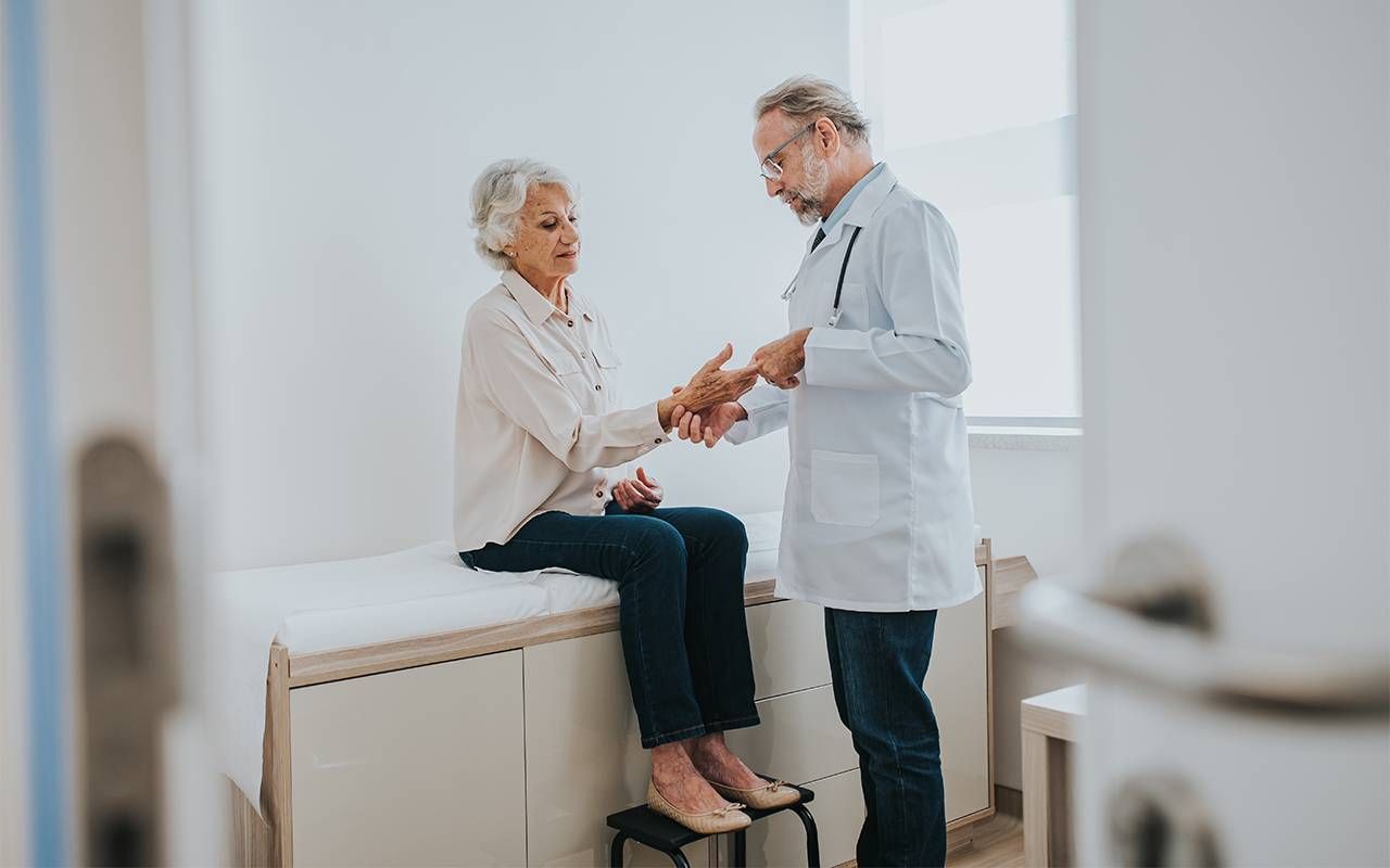 An older adult with lupus talking to her doctor. Next Avenue, lupus, aging