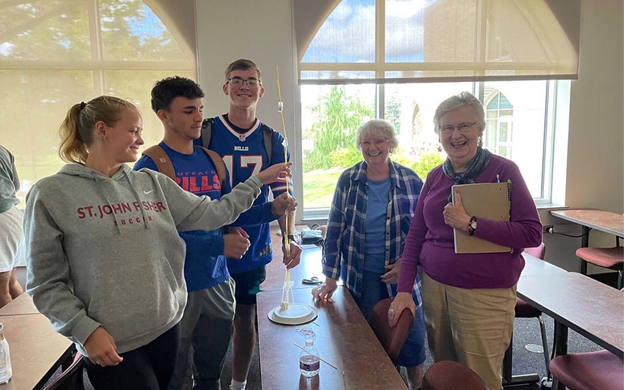 A professor with students in a college classroom. Next Avenue