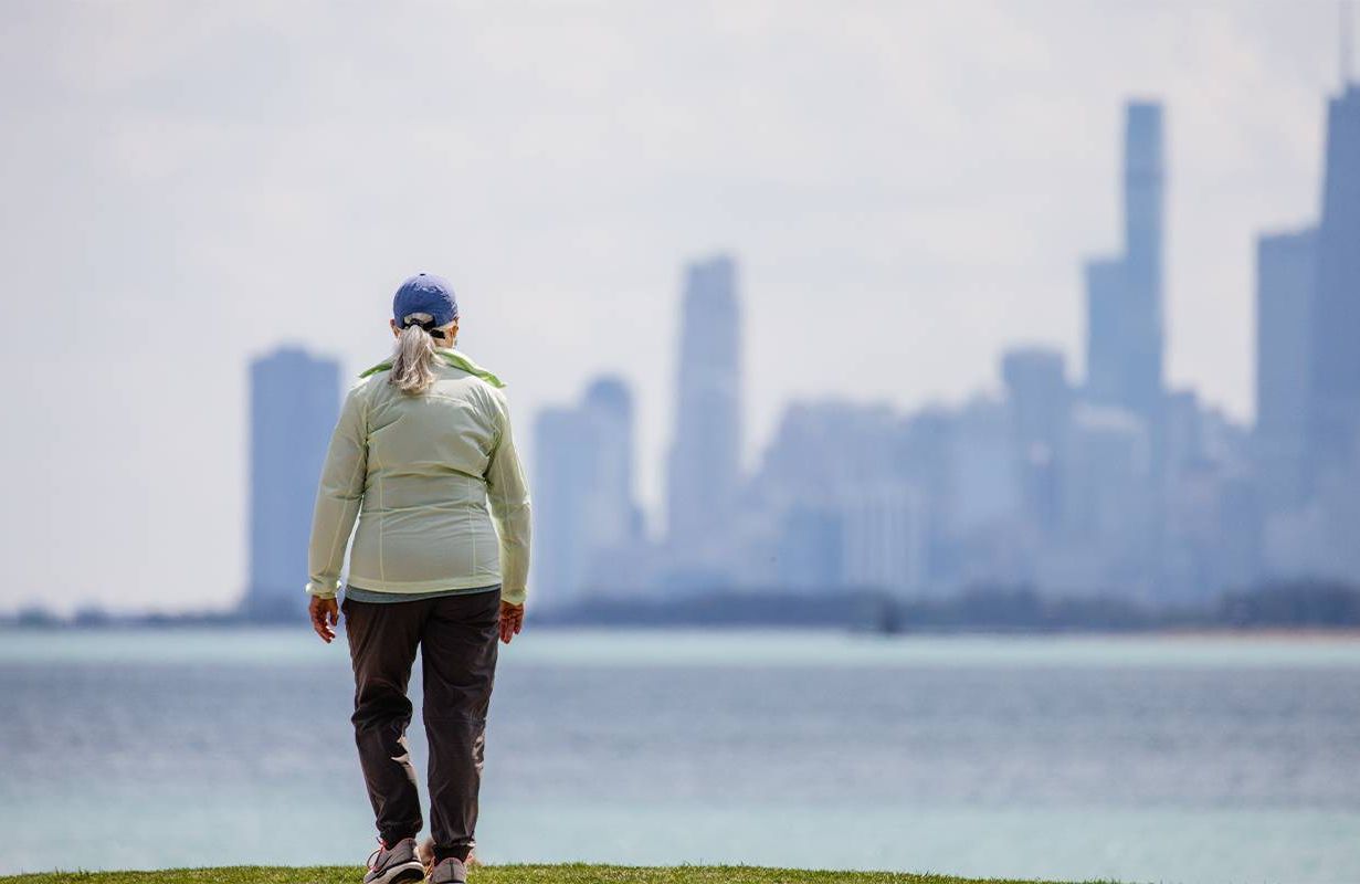 A woman walking along the lakeshore in Chicago. Next Avenue