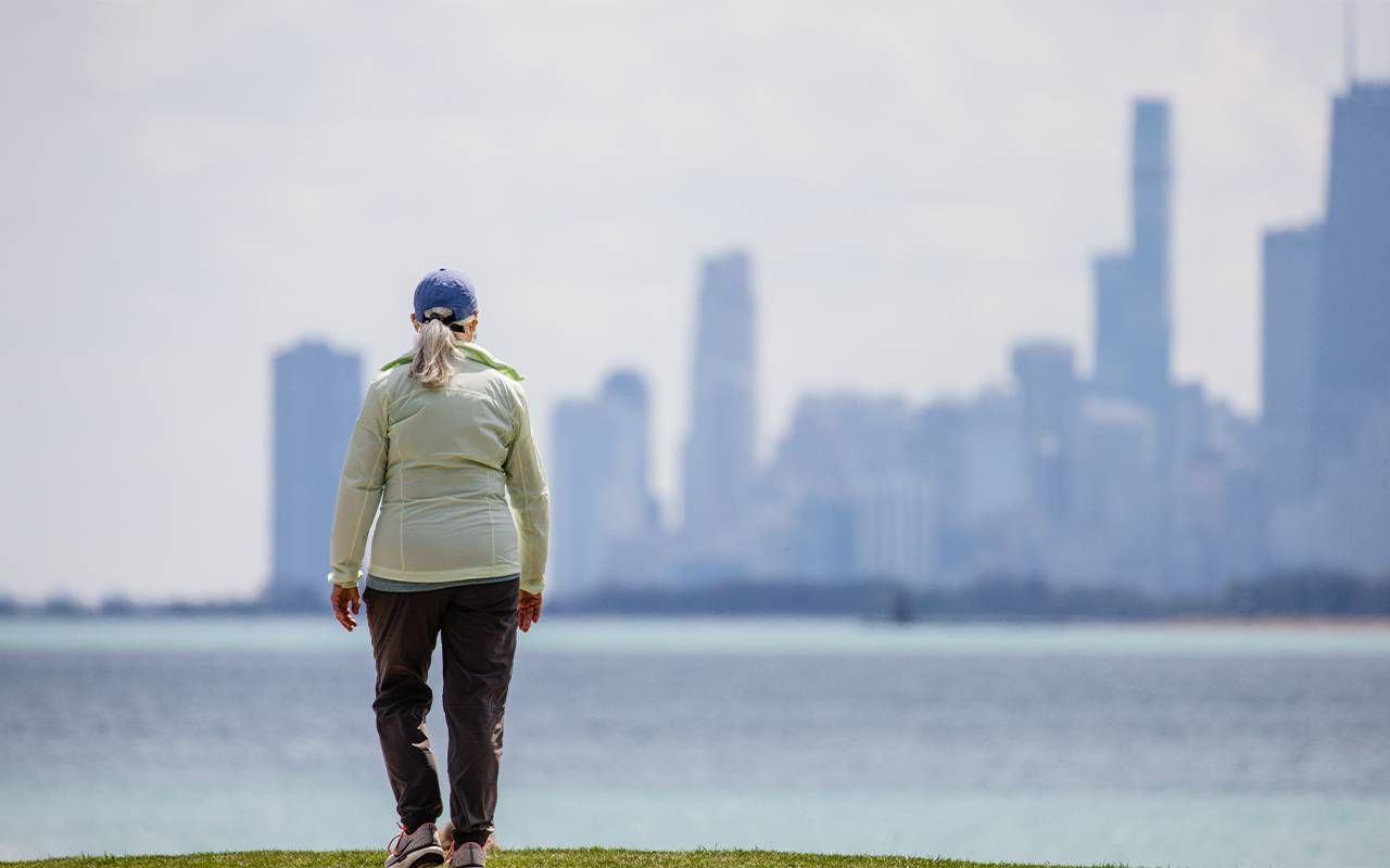 A woman walking along the lakeshore in Chicago. Next Avenue